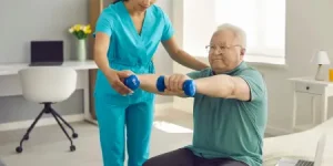 Physiotherapist-helping-senior-improve-mobility